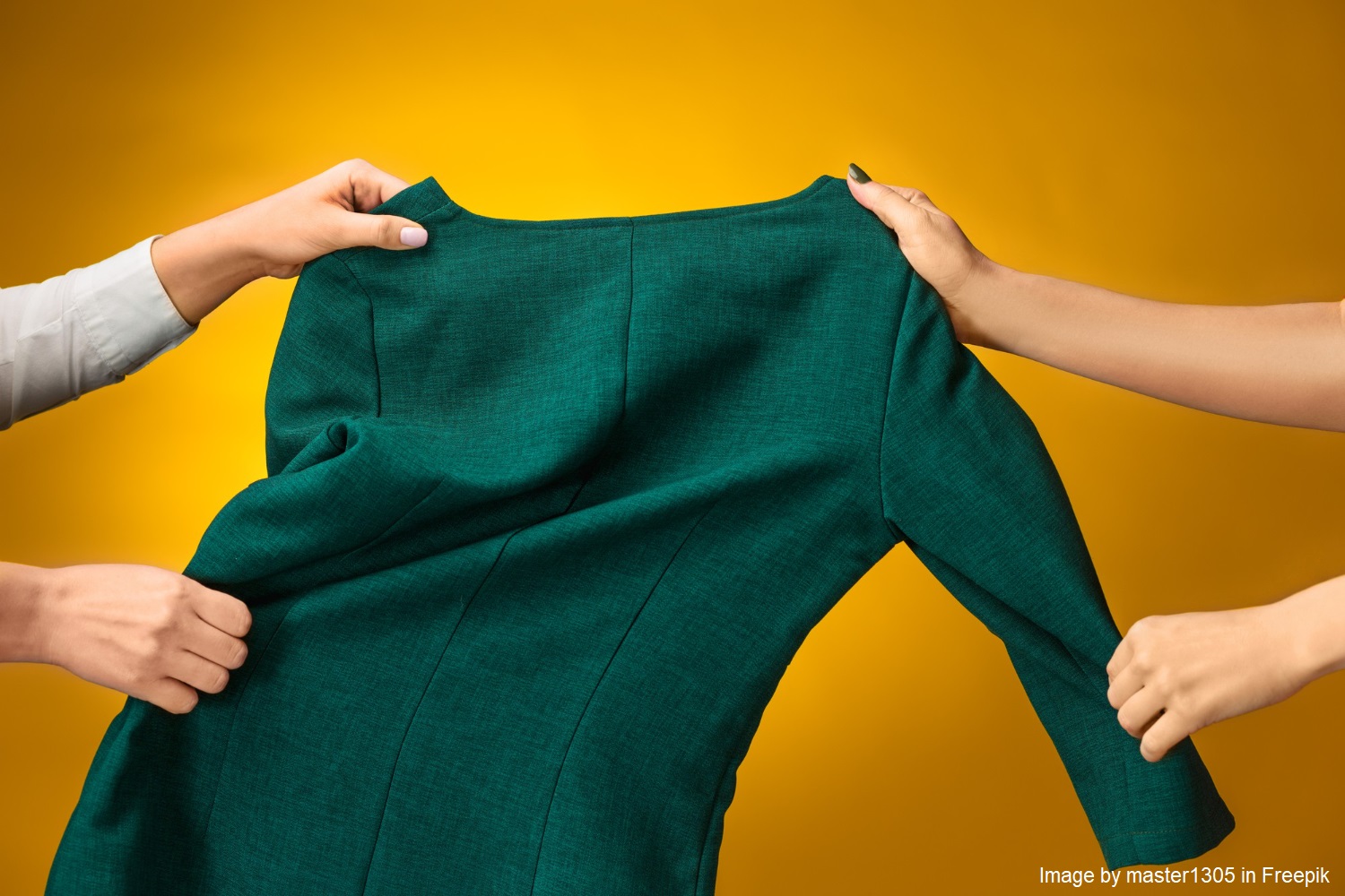 An image of a two pairs of hands pulling a green dress on a yellow background.
