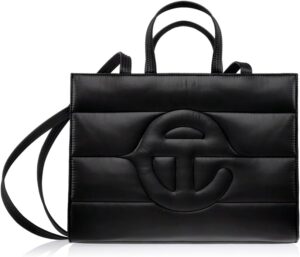 An image of a black circular fashion Telfar tote bag. It has a double strap, that can be worn over the shoulder, hand or crossbody.