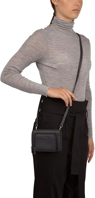 A woman wearing a Matt & Nat Vegan Crossbody bag perfect for running errands or on a casual day out.