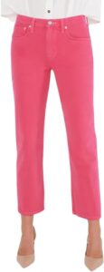 Model wearing ÉTICA Women's mid-rise jeans in a vibrant raspberry pink wash, featuring a straight-leg fit, paired with a white shirt and nude heels, standing against a white background.